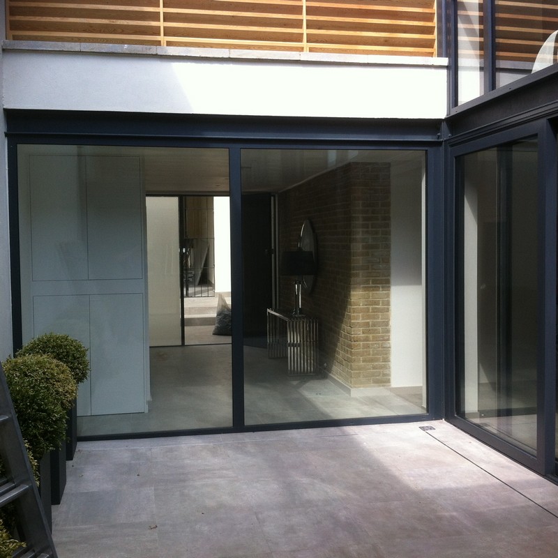 Floor-to-ceiling sliding doors opening to courtyard in Waterloo